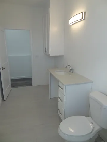 a white toilet sitting next to a bathroom sink