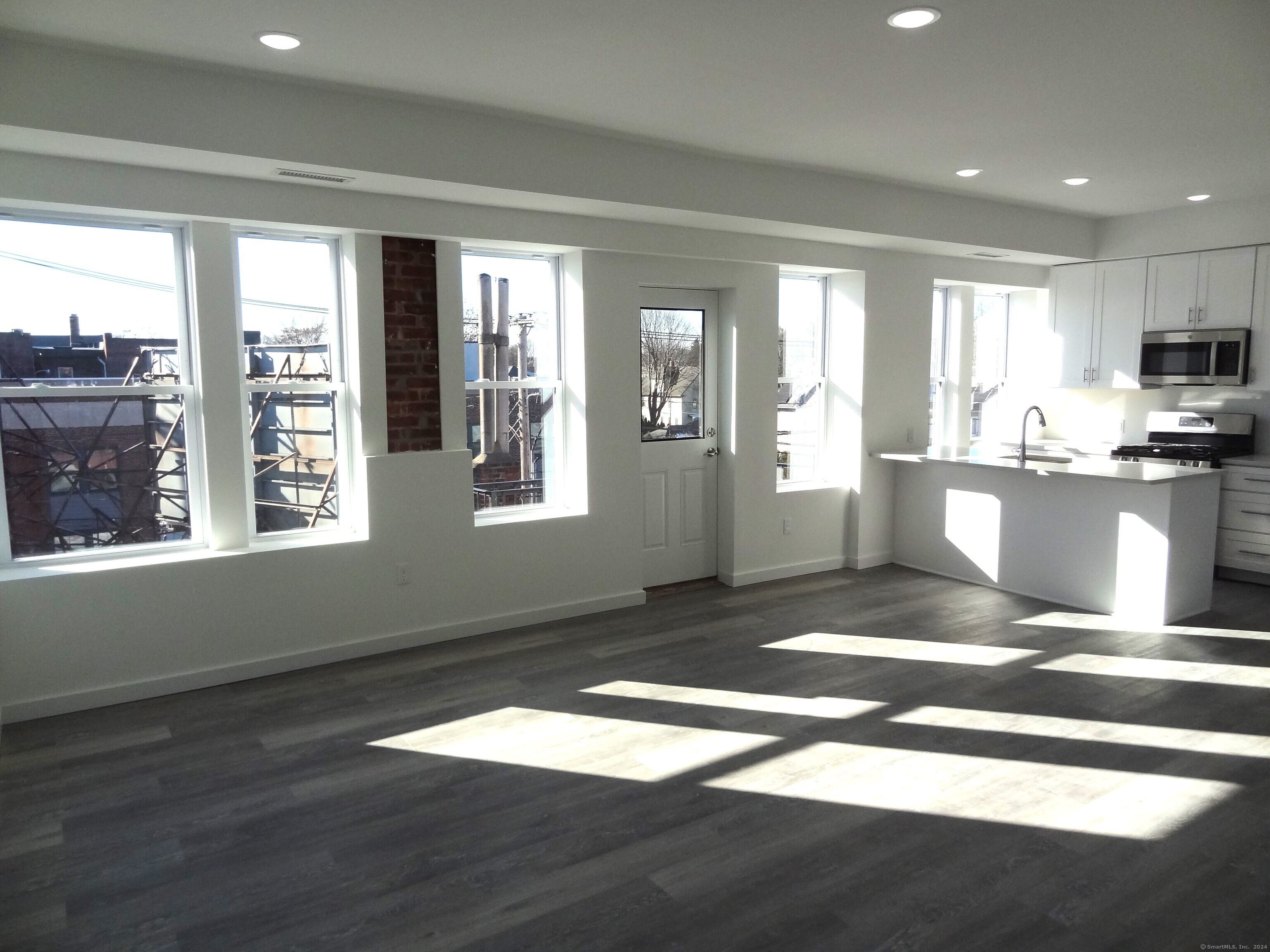 2806 Fairfield Avenue, Unit 207 Bridgeport, CT 06605 - Photo 2 of 24 a view of a kitchen with wooden floor and a kitchen