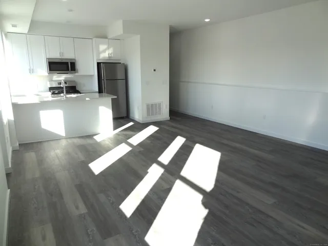 a kitchen with a sink appliances and cabinets