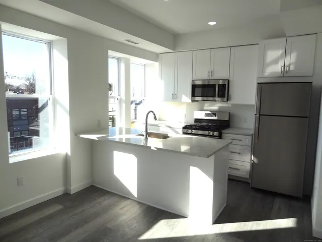 a kitchen with a refrigerator and a sink