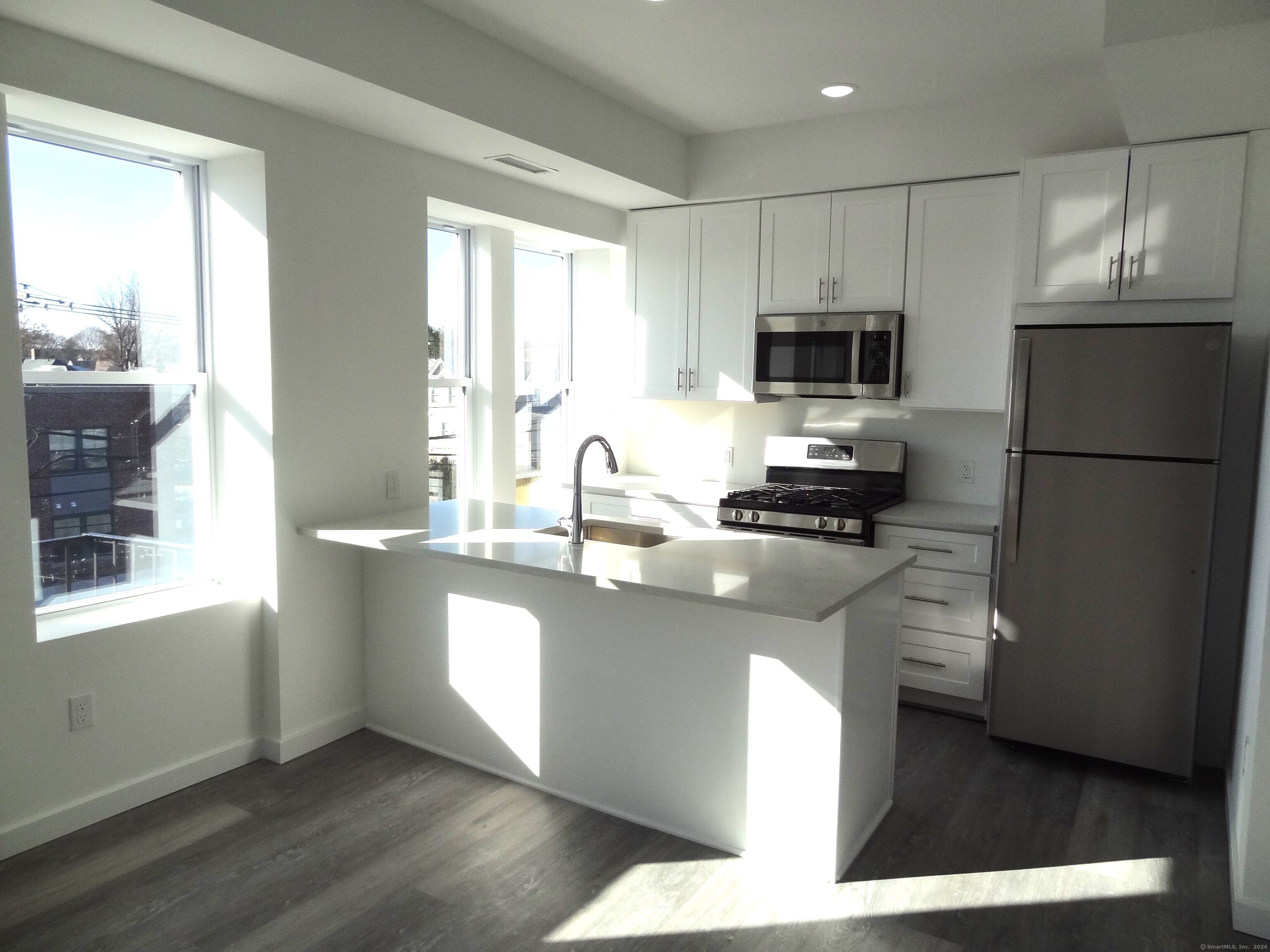 2806 Fairfield Avenue, Unit 207 Bridgeport, CT 06605 - Photo 4 of 24 a kitchen with a refrigerator and a sink