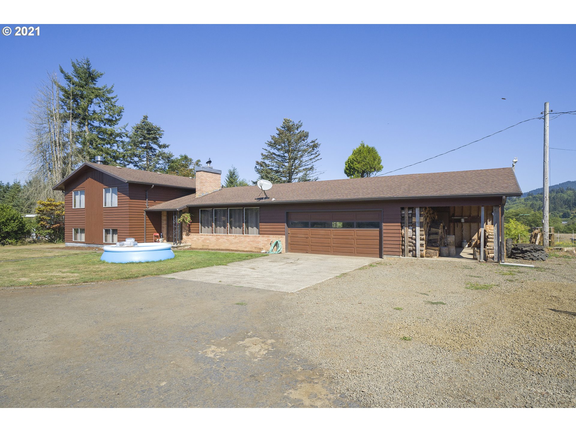 10050 Chance Road Tillamook, OR 97141 - Photo 1 of 31 a front view of a house with a yard and garage