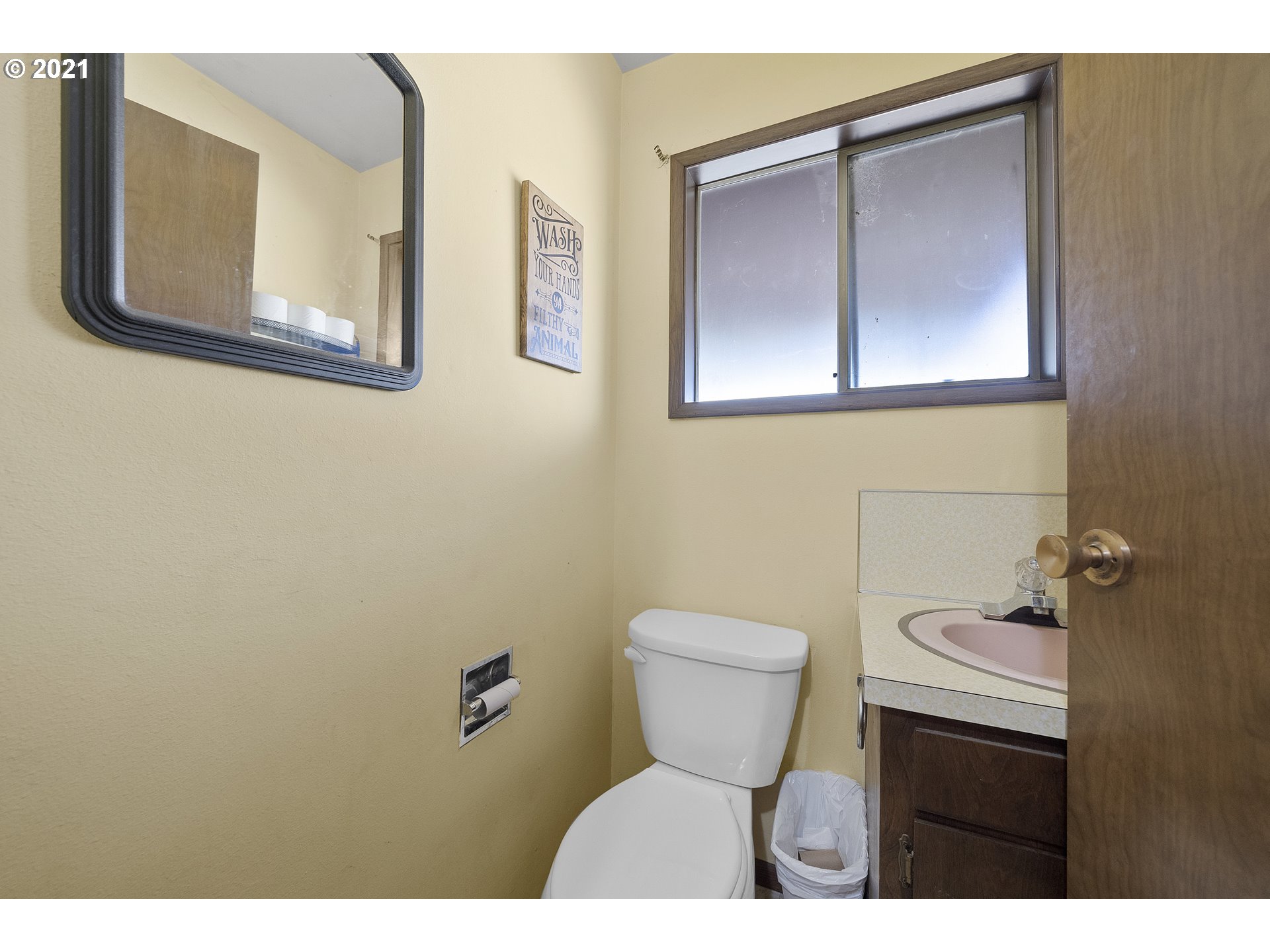 10050 Chance Road Tillamook, OR 97141 - Photo 26 of 31 a bathroom with a toilet sink and mirror