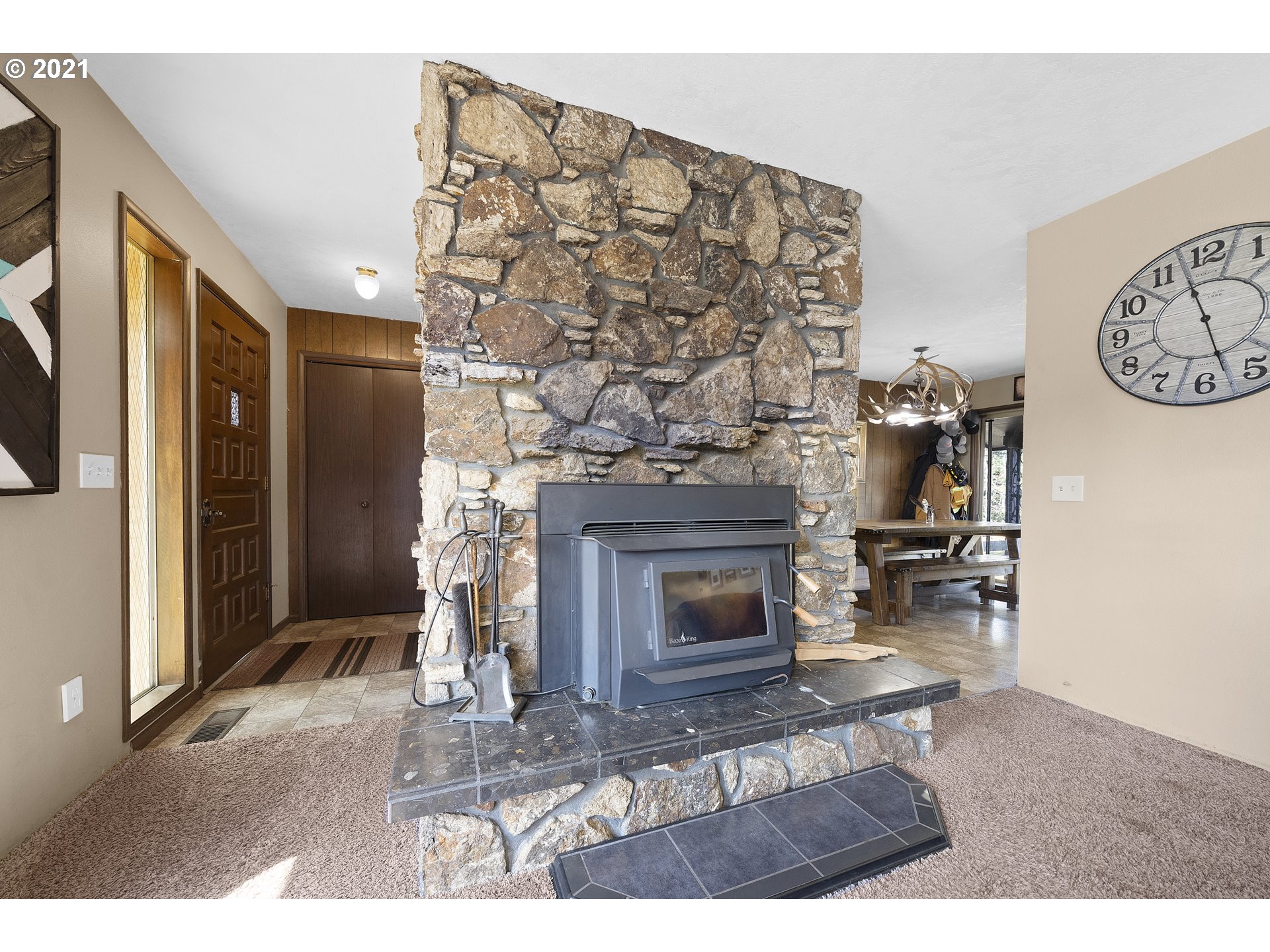 10050 Chance Road Tillamook, OR 97141 - Photo 7 of 31 a living room with furniture a fireplace and a flat screen tv