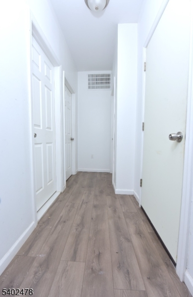 a view of a room with wooden floor