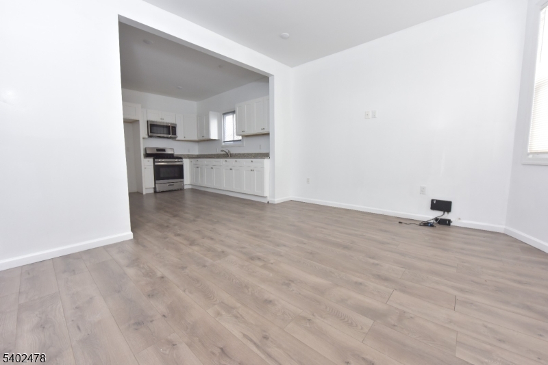 473 Grove Street, Unit 1 Irvington, NJ 07111 - Photo 12 of 17 a view of a kitchen with a sink and a stove