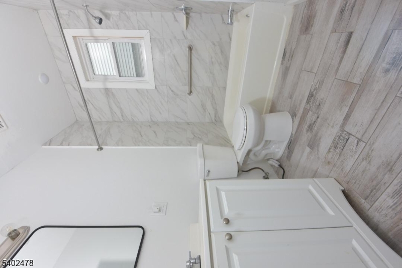 473 Grove Street, Unit 1 Irvington, NJ 07111 - Photo 7 of 17 a bathroom with a sink and a mirror