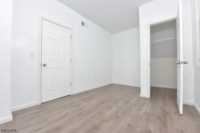 an empty room with wooden floor