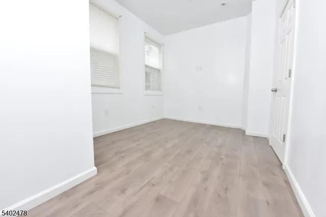 a view of a room with wooden floor