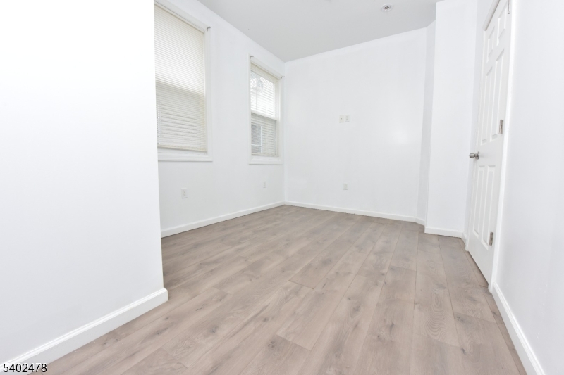 473 Grove Street, Unit 1 Irvington, NJ 07111 - Photo 9 of 17 a view of a room with wooden floor