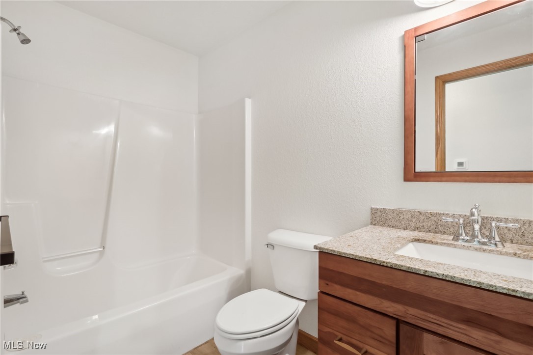 476 Garrison Road Ashtabula, OH 44004 - Photo 39 of 50 Full bathroom featuring vanity, toilet, and washtub / shower combination