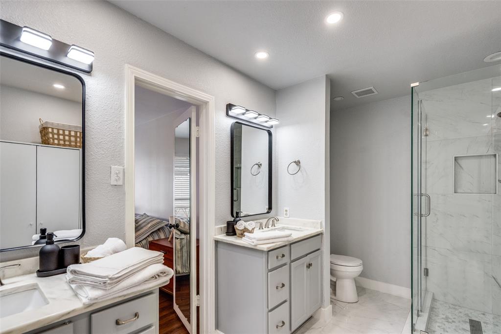 15642 Overmead Circle Dallas, TX 75248 - Photo 17 of 24 a bathroom with a granite countertop sink toilet and shower