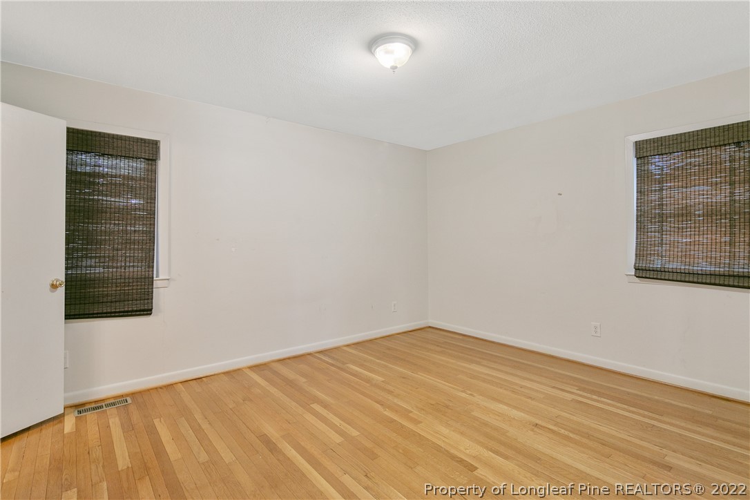 6309 Greyfield Road Fayetteville, NC 28303 - Photo 20 of 45 a view of an empty room with wooden floor and a window
