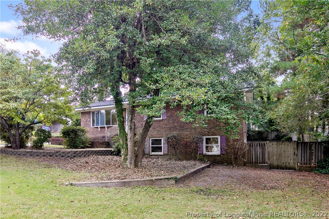 6309 Greyfield Road Fayetteville, NC 28303 - Photo 2 of 45 a view of a yard in front of a house with large tree