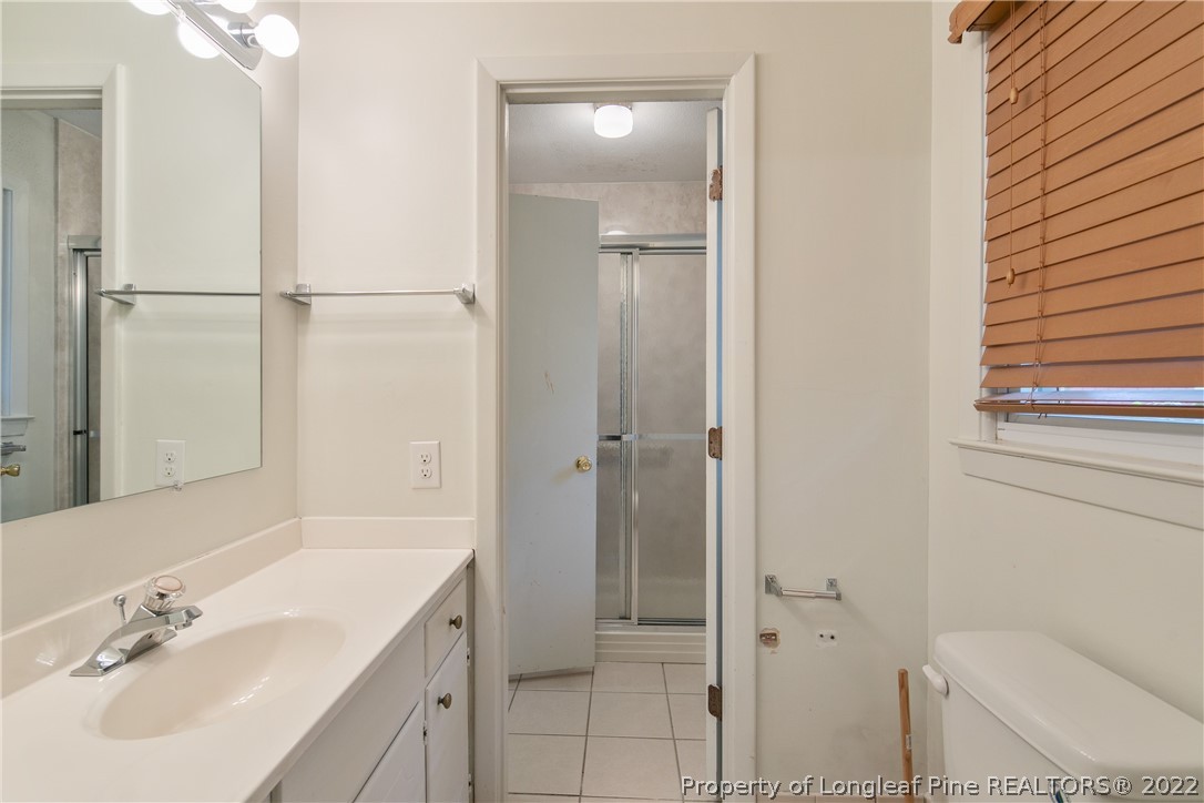 6309 Greyfield Road Fayetteville, NC 28303 - Photo 24 of 45 a bathroom with a sink toilet and shower