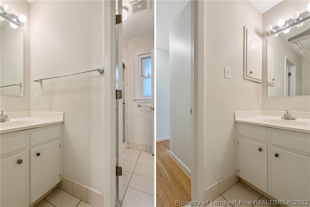 6309 Greyfield Road Fayetteville, NC 28303 - Photo 29 of 45 a bathroom with a sink and mirror with shower