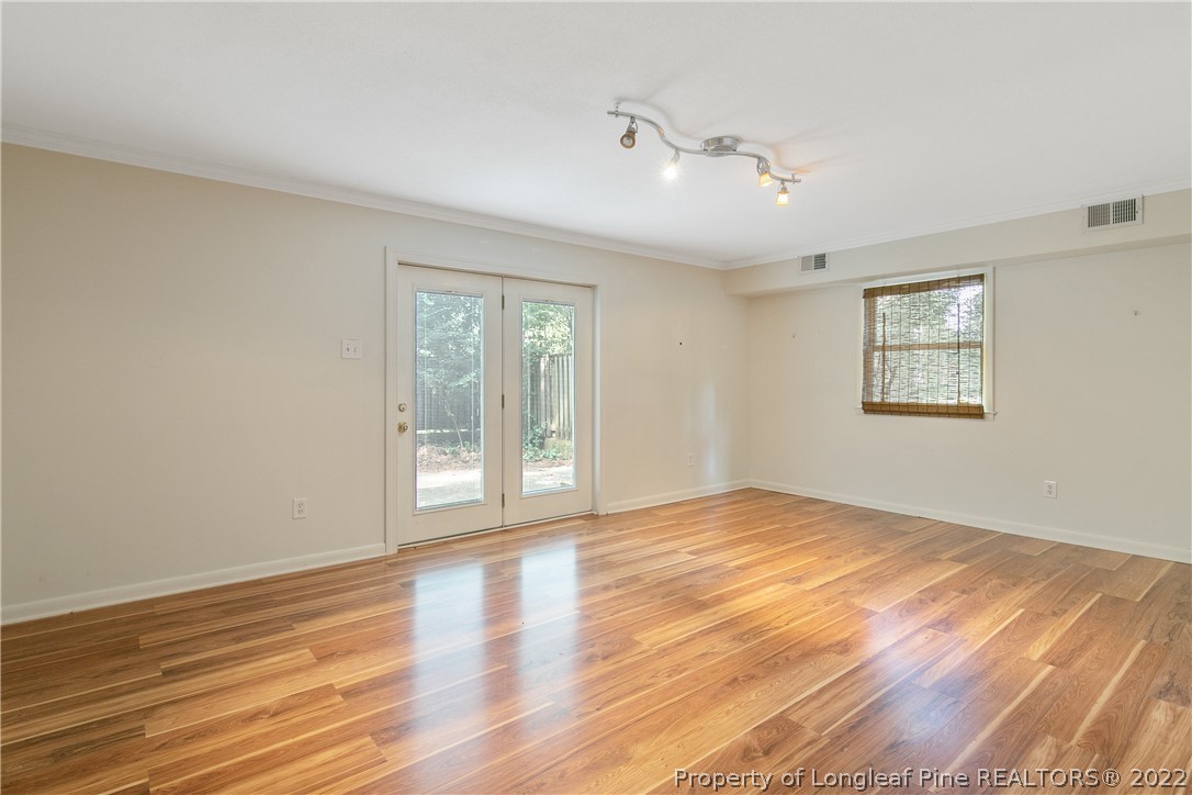 6309 Greyfield Road Fayetteville, NC 28303 - Photo 30 of 45 a view of an empty room with wooden floor and a window