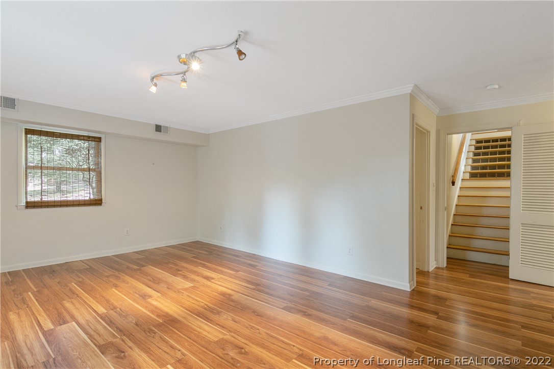 6309 Greyfield Road Fayetteville, NC 28303 - Photo 31 of 45 a view of empty room with wooden floor and fan