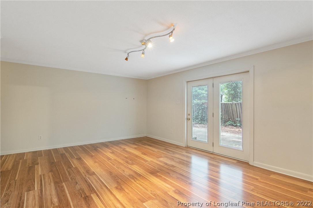 6309 Greyfield Road Fayetteville, NC 28303 - Photo 33 of 45 a view of an empty room with wooden floor and a window