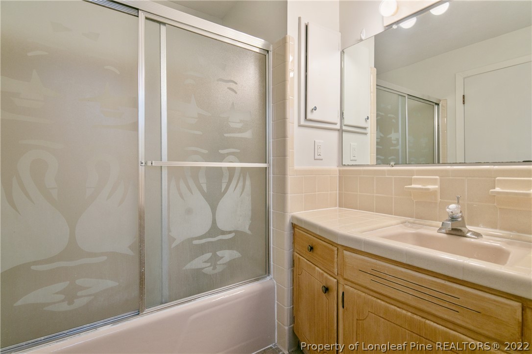 6309 Greyfield Road Fayetteville, NC 28303 - Photo 36 of 45 a bathroom with a shower and a sink