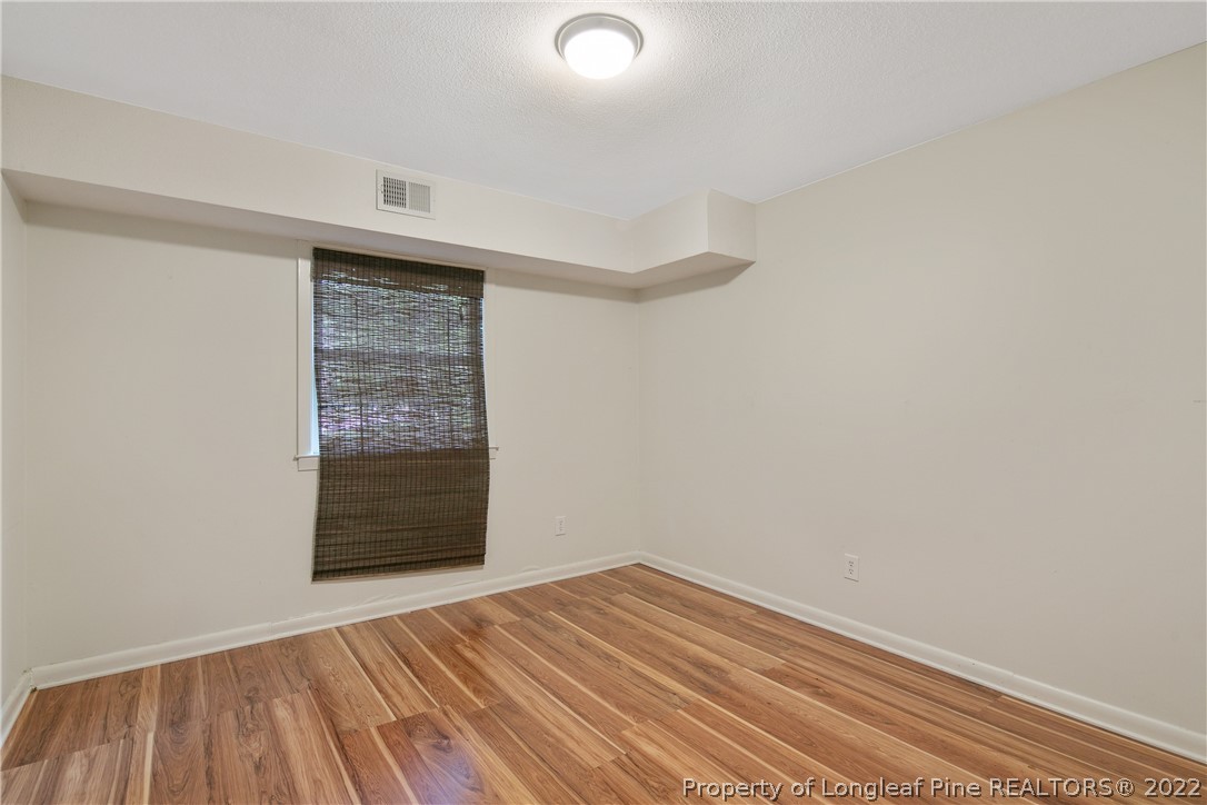 6309 Greyfield Road Fayetteville, NC 28303 - Photo 37 of 45 a view of empty room with wooden floor and fan