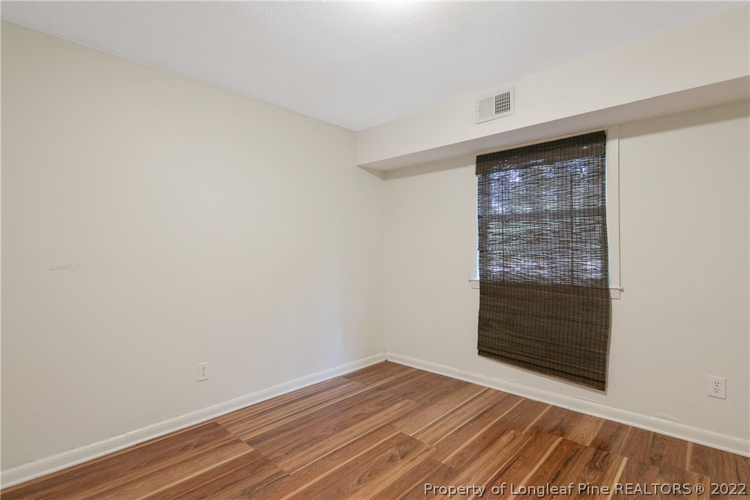6309 Greyfield Road Fayetteville, NC 28303 - Photo 40 of 45 a view of an empty room with wooden floor and cabinet