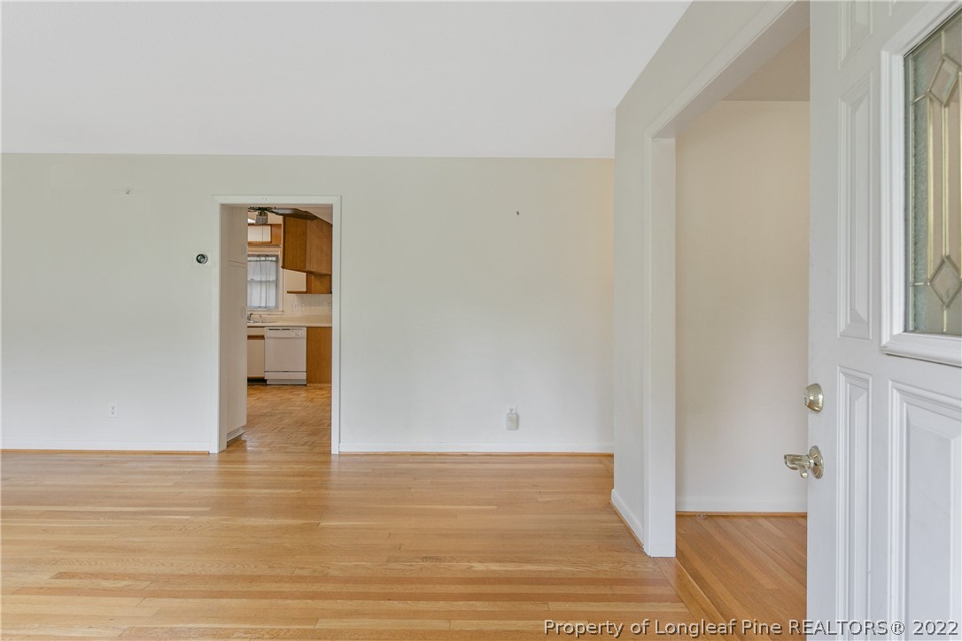 6309 Greyfield Road Fayetteville, NC 28303 - Photo 5 of 45 a view of empty room with wooden floor and fan