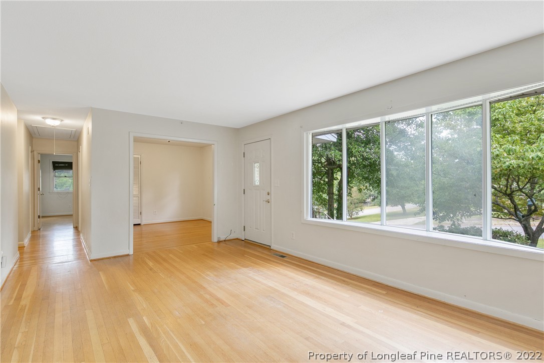 6309 Greyfield Road Fayetteville, NC 28303 - Photo 7 of 45 a view of an empty room with wooden floor and a window