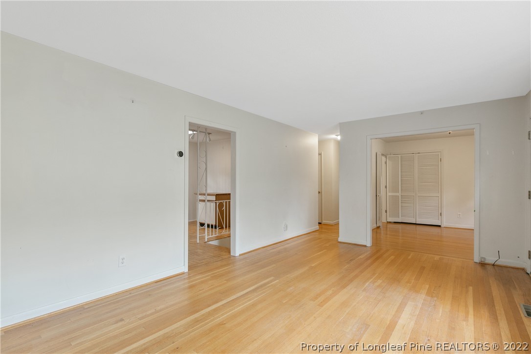 6309 Greyfield Road Fayetteville, NC 28303 - Photo 8 of 45 a view of an empty room with wooden floor and a window