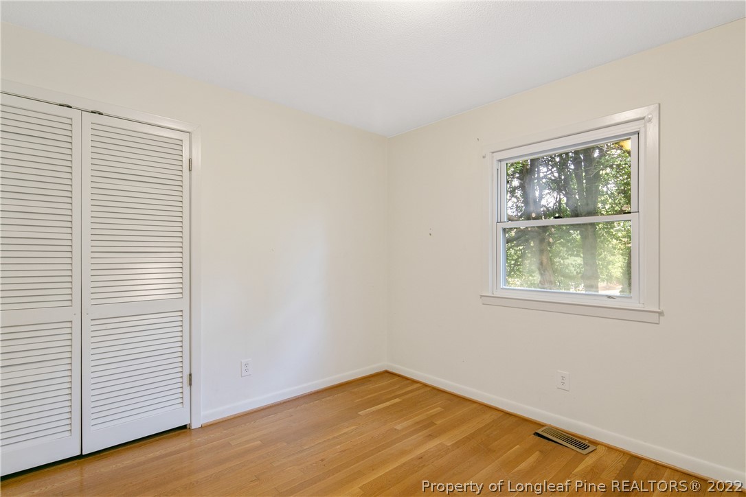6309 Greyfield Road Fayetteville, NC 28303 - Photo 9 of 45 an empty room with wooden floor and windows