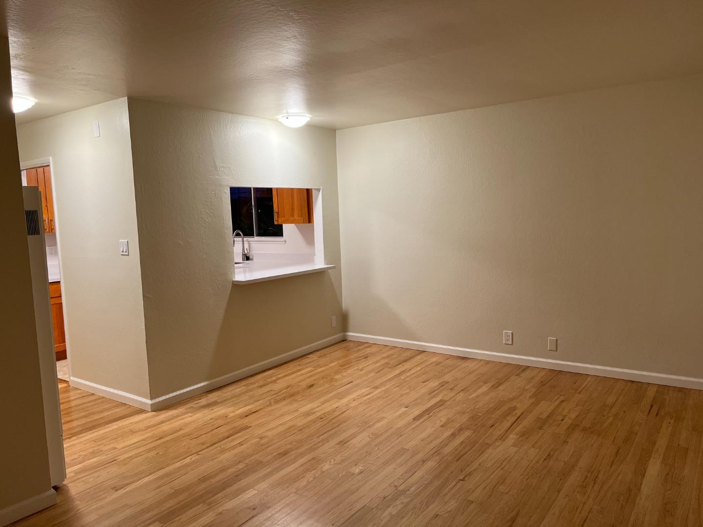 1506 Shoreview Avenue, Unit 6 San Mateo, CA 94401 - Photo 5 of 13 a view of room with wooden floor and flat screen tv