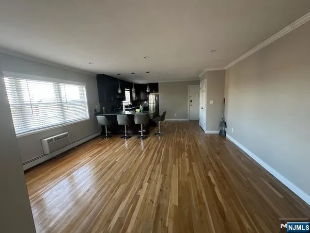 a view of dining room with furniture wooden floor and windows