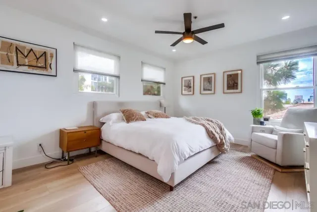a bedroom with a large bed and a window