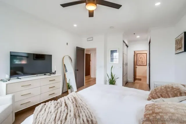 a bedroom with a bed and a flat screen tv in it