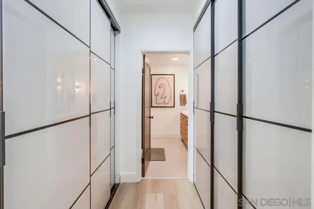a view of a hallway with wooden floor