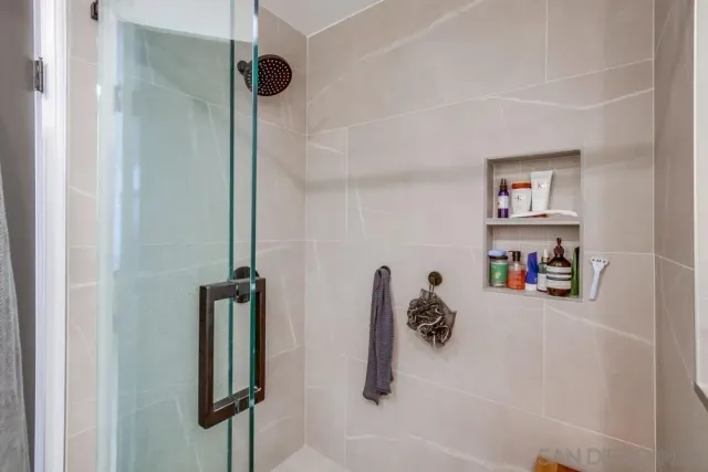 a bathroom with a shower and a mirror