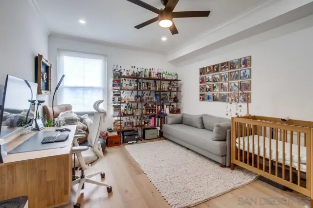 a bedroom with furniture and baby crib