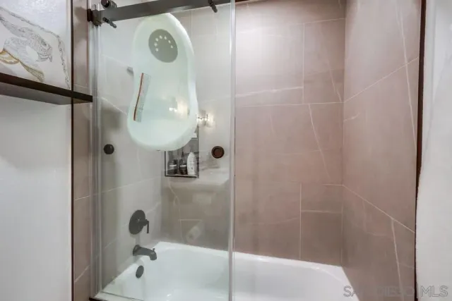 a kitchen with granite countertop white cabinets and stainless steel appliances