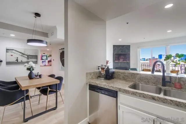 a kitchen with stainless steel appliances granite countertop a sink a stove and a refrigerator