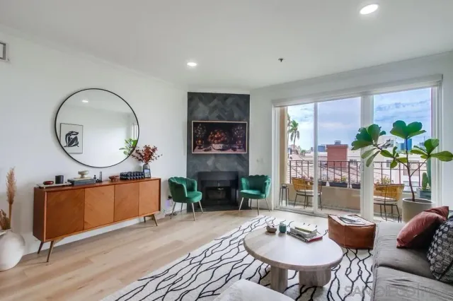 a living room with furniture a fireplace and a large mirror