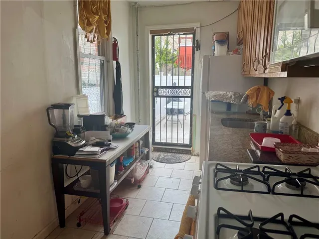 a kitchen with a stove a sink and cabinets