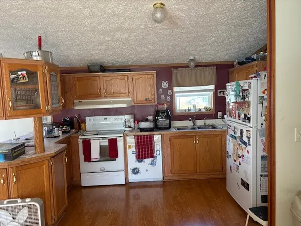 a kitchen with stainless steel appliances granite countertop a stove and a refrigerator