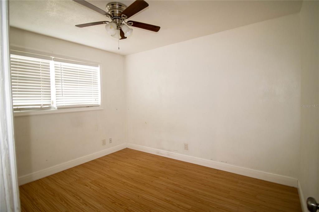 809 Maley Street Daytona Beach, FL 32114 - Photo 13 of 15 wooden floor in an empty room with a window