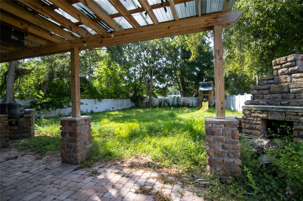 809 Maley Street Daytona Beach, FL 32114 - Photo 14 of 15 a view of a garden with plants and large trees