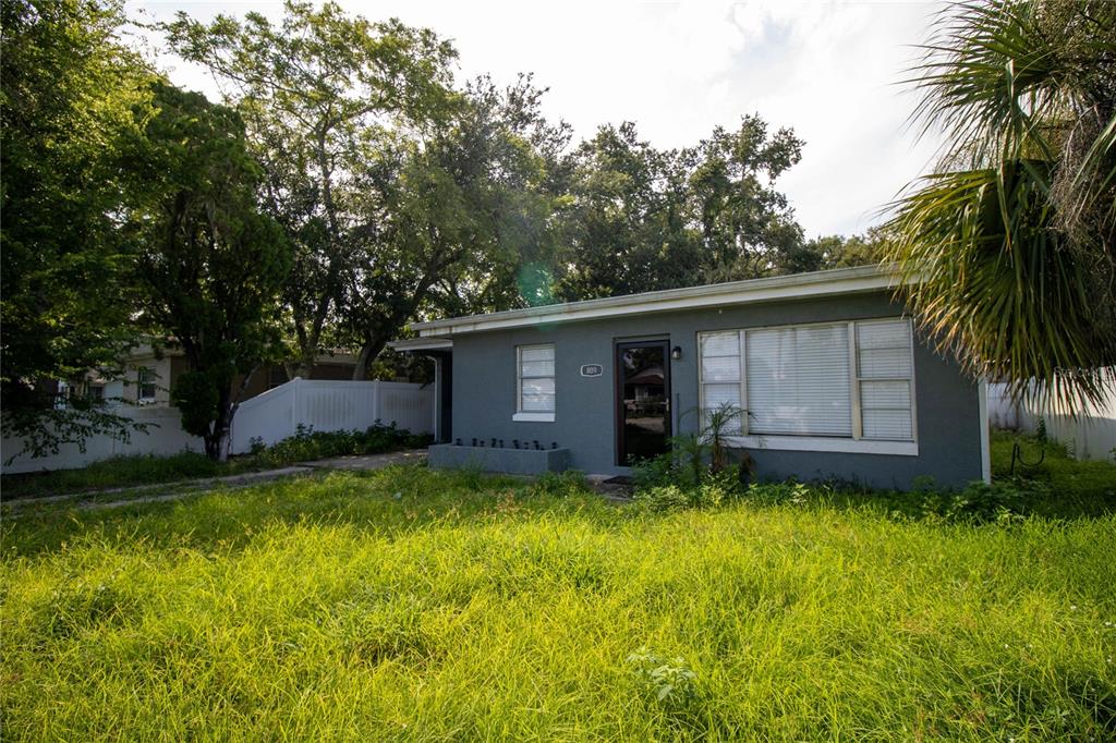 809 Maley Street Daytona Beach, FL 32114 - Photo 3 of 15 a view of a backyard with a large tree