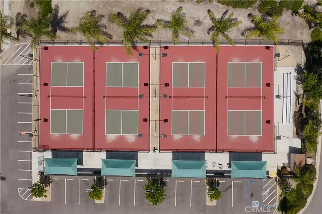 an aerial view of a house with a yard and large tree