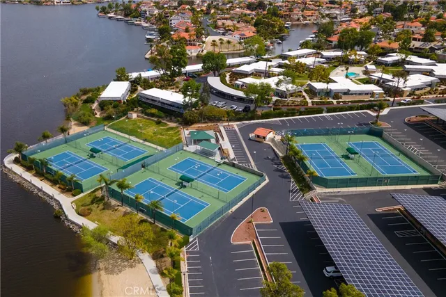 an aerial view of a residential houses with yard