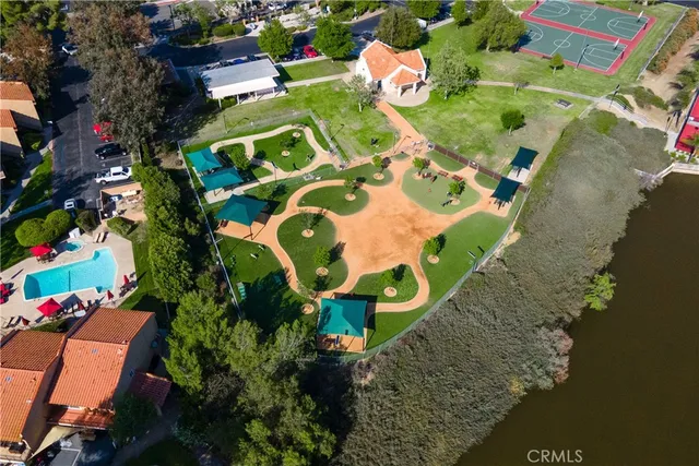 an aerial view of a house with a yard and lake view