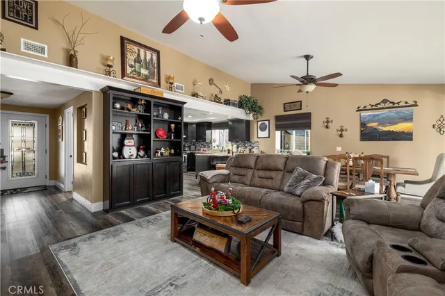 a living room with furniture a flat screen tv and a large window