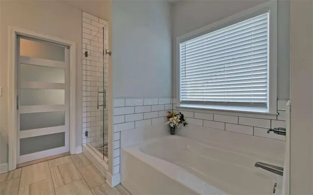 a bathroom with a bathtub and a shower